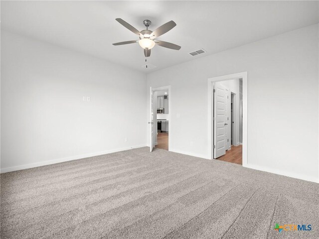 1513 Passmore Downs, New Braunfels, TX 78130 - unfurnished bedroom with carpet flooring, baseboards, and a ceiling fan