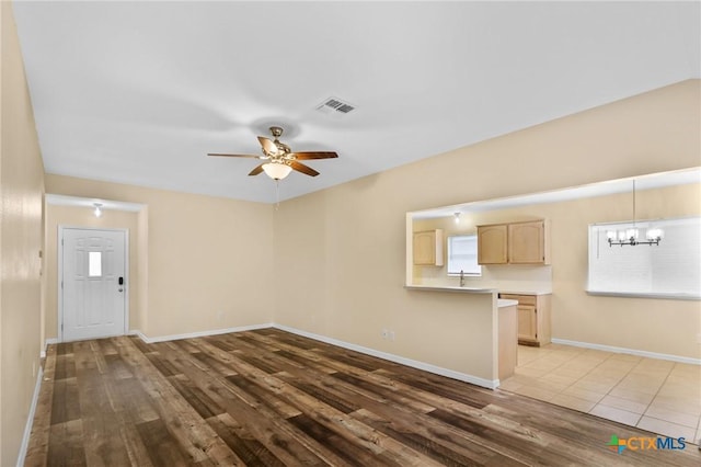 501 Appaloosa Dr, Victoria, TX 77904 - unfurnished living room featuring wood finished floors, ceiling fan, and a chandelier