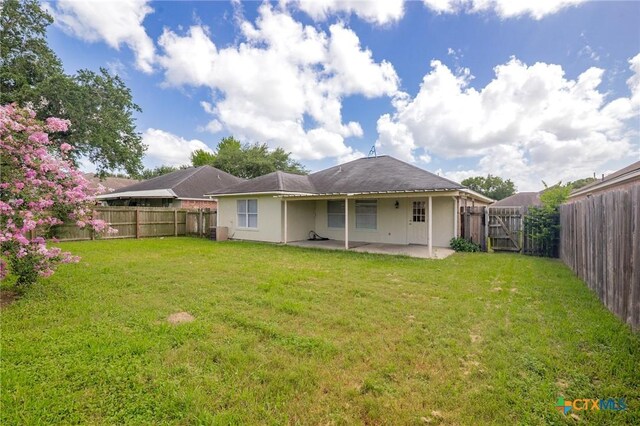 501 Appaloosa Dr, Victoria, TX 77904 - rear view of property with a patio area, a fenced backyard, and stucco siding