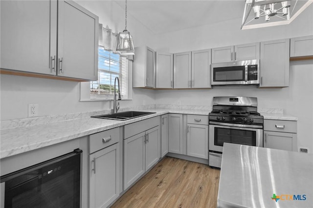 905 N Navarro St, Victoria, TX 77901 - kitchen with appliances with stainless steel finishes, wine cooler, gray cabinets, and light wood-type flooring