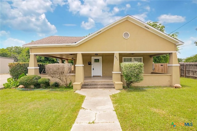 905 N Navarro St, Victoria, TX 77901 - view of front of property with stucco siding and a porch