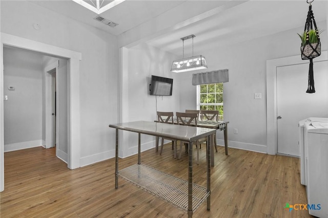 905 N Navarro St, Victoria, TX 77901 - dining room featuring washer and dryer and wood finished floors