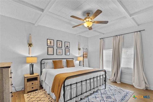 905 N Navarro St, Victoria, TX 77901 - bedroom featuring coffered ceiling, light wood finished floors, beam ceiling, and ceiling fan