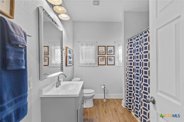 905 N Navarro St, Victoria, TX 77901 - bathroom with vanity, wood finished floors, and curtained shower