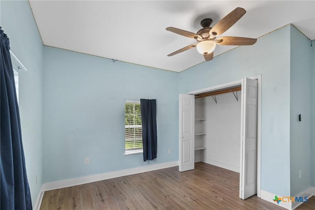 905 N Navarro St, Victoria, TX 77901 - unfurnished bedroom featuring wood finished floors, ceiling fan, and a closet
