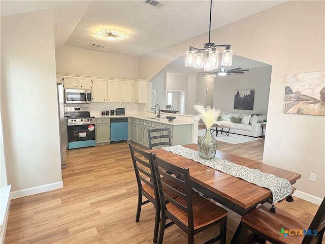 421 Arapaho Dr, Harker Heights, TX 76548 - dining area with light wood-style floors, baseboards, a textured ceiling, and a ceiling fan