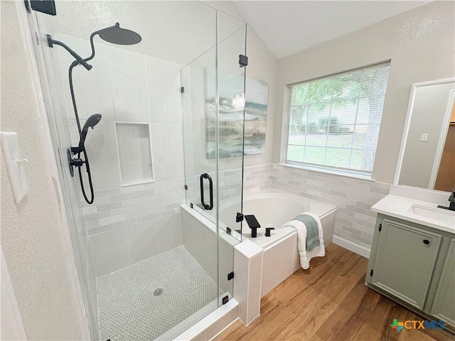 421 Arapaho Dr, Harker Heights, TX 76548 - full bathroom with a stall shower, wood finished floors, a bath, vanity, and a textured ceiling