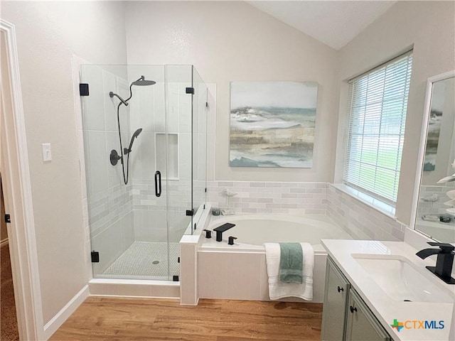 421 Arapaho Dr, Harker Heights, TX 76548 - bathroom featuring a garden tub, vanity, a shower stall, vaulted ceiling, and plenty of natural light