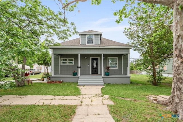 bungalow-style home with a porch, a shingled roof, and a front yard