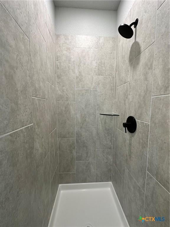 full bathroom featuring tiled shower