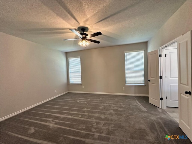 unfurnished bedroom with carpet floors, a textured ceiling, baseboards, and ceiling fan