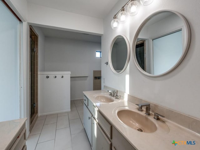 bathroom with double vanity, tile patterned flooring, a sink, and a shower with shower door