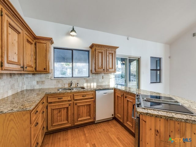 kitchen with light wood-style flooring, brown cabinetry, range, a peninsula, and dishwasher