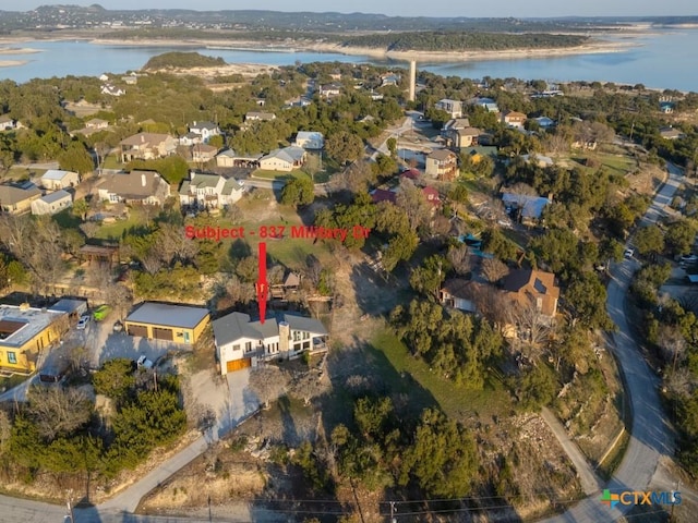 birds eye view of property with a water view and a residential view