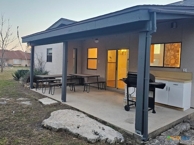 back of house featuring a patio area and stucco siding