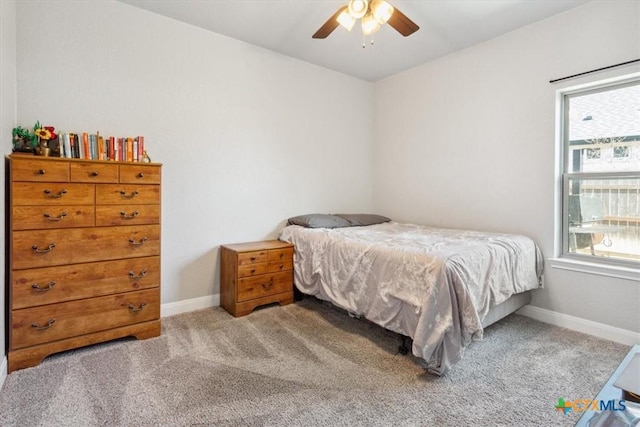 bedroom featuring baseboards, a ceiling fan, and light colored carpet