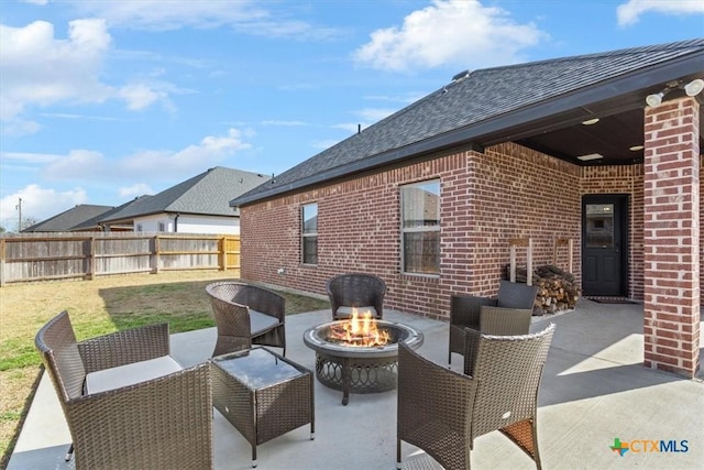 view of patio / terrace featuring fence and a fire pit