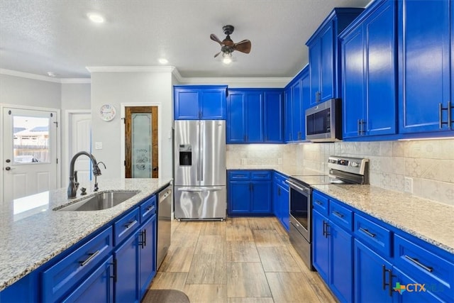 kitchen featuring stainless steel appliances, tasteful backsplash, a sink, and crown molding