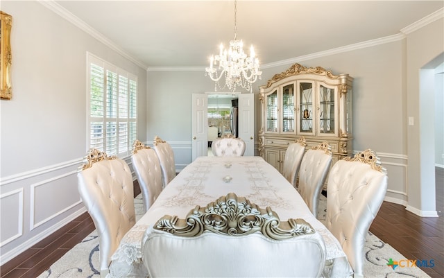 dining room featuring dark hardwood / wood-style flooring, an inviting chandelier, and crown molding