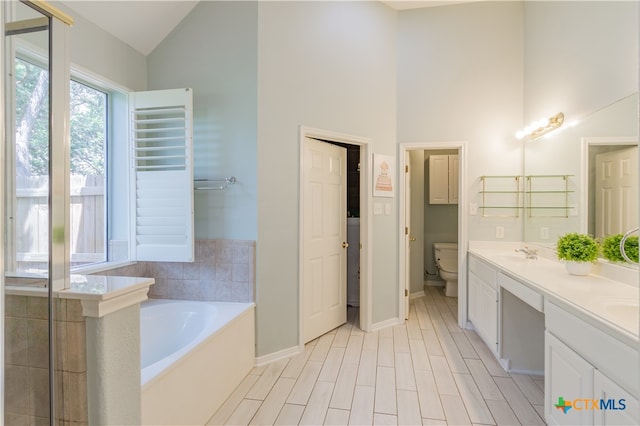 bathroom with radiator heating unit, toilet, high vaulted ceiling, a bathtub, and vanity