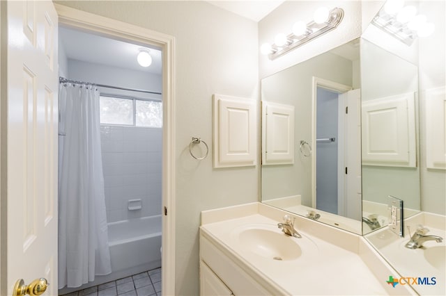 bathroom with shower / bath combo, vanity, and tile patterned floors