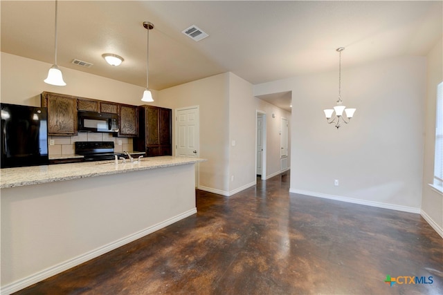 kitchen with hanging light fixtures, black appliances, sink, and light stone countertops