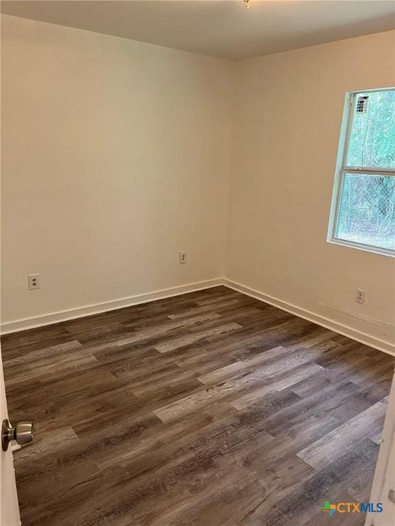 255 Pollard St, Beaumont, TX 77703 - spare room featuring dark wood-style floors and baseboards