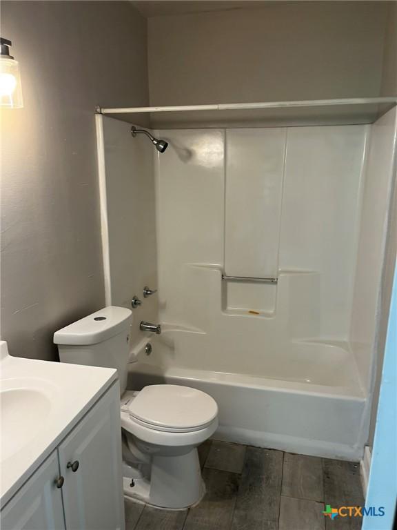 255 Pollard St, Beaumont, TX 77703 - bathroom featuring vanity, toilet, washtub / shower combination, and wood finished floors