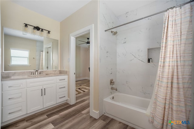 bathroom with vanity, hardwood / wood-style flooring, shower / bath combo with shower curtain, and ceiling fan