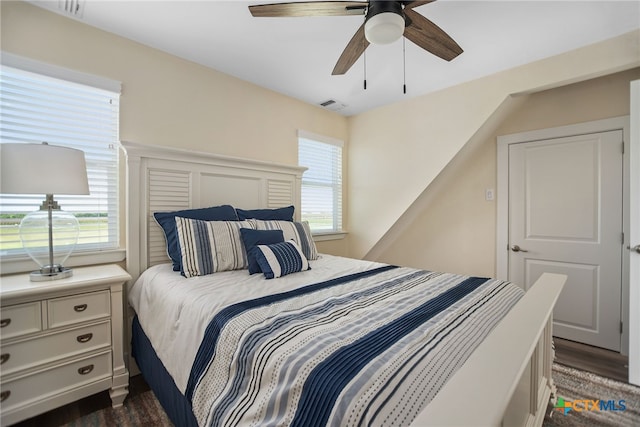 bedroom featuring ceiling fan and dark hardwood / wood-style floors