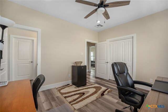 office area featuring wood-type flooring and ceiling fan