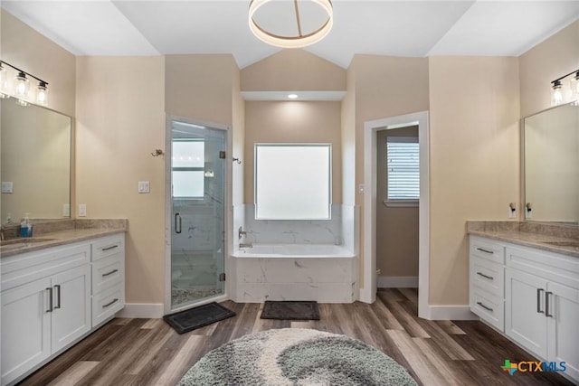 105 N Redfish Retreat Dr, Port Lavaca, TX 77979 - full bath featuring lofted ceiling, baseboards, two vanities, a stall shower, and a garden tub