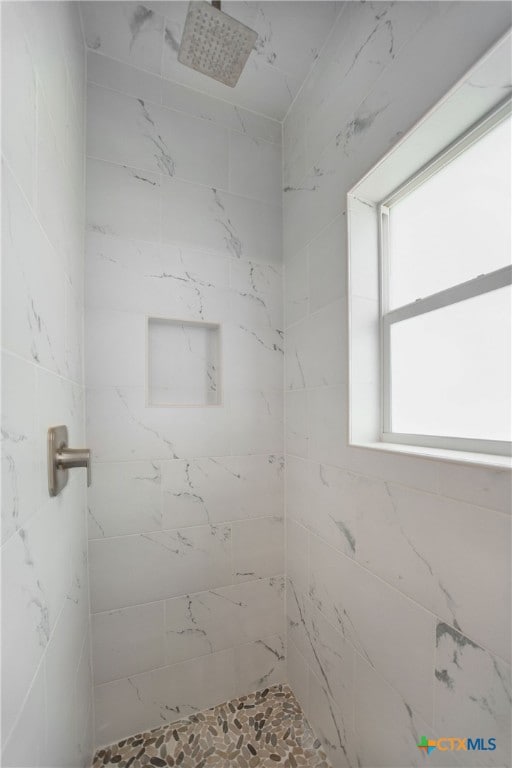 bathroom with a tile shower