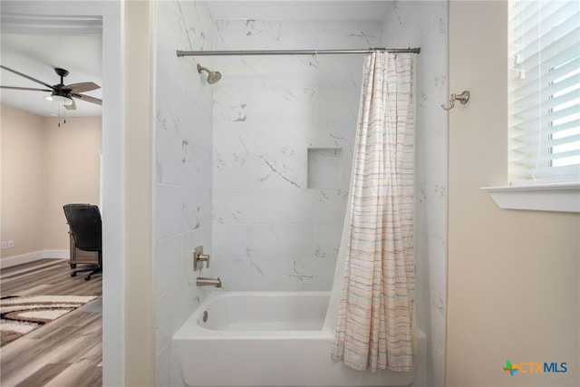 bathroom with ceiling fan, wood-type flooring, and shower / bath combo