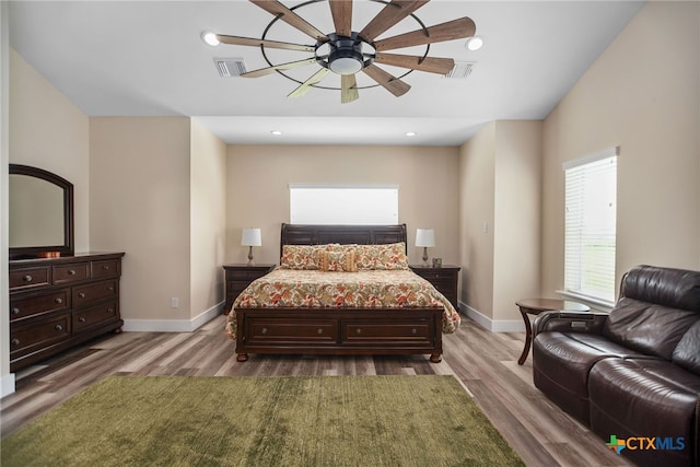 bedroom with hardwood / wood-style floors and ceiling fan