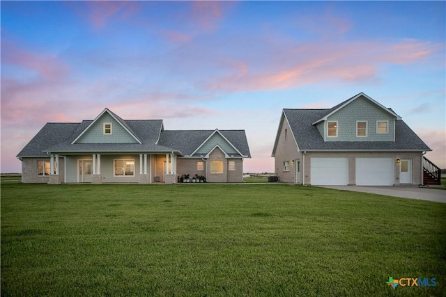 105 N Redfish Retreat Dr, Port Lavaca, TX 77979 - view of front of house featuring concrete driveway, covered porch, a front lawn, a garage, and roof with shingles