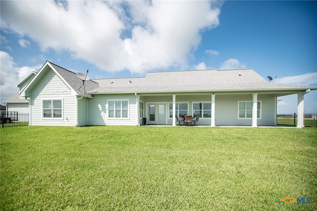 back of property featuring a patio and a yard