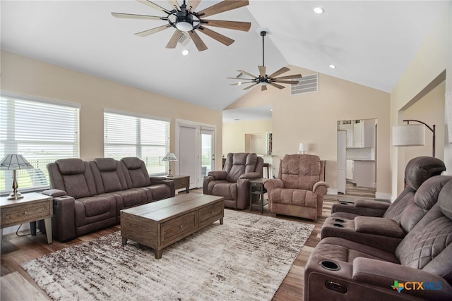 living room with high vaulted ceiling, hardwood / wood-style floors, and ceiling fan