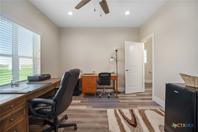 office featuring light wood-type flooring and ceiling fan