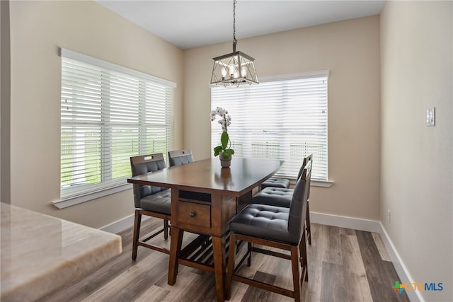 dining space with a chandelier and hardwood / wood-style floors