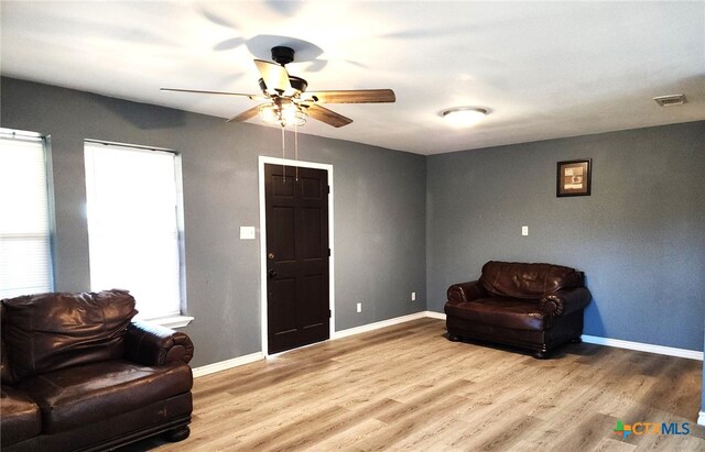 sitting room with light hardwood / wood-style floors and ceiling fan