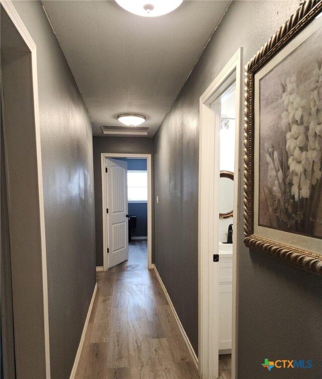 hall with light hardwood / wood-style flooring