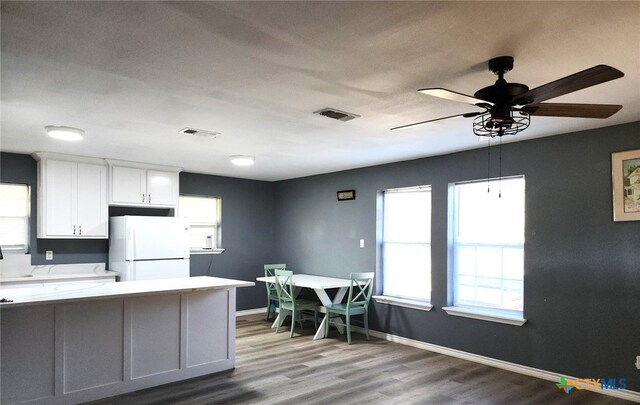 kitchen with ceiling fan, sink, wood-type flooring, white cabinets, and white fridge