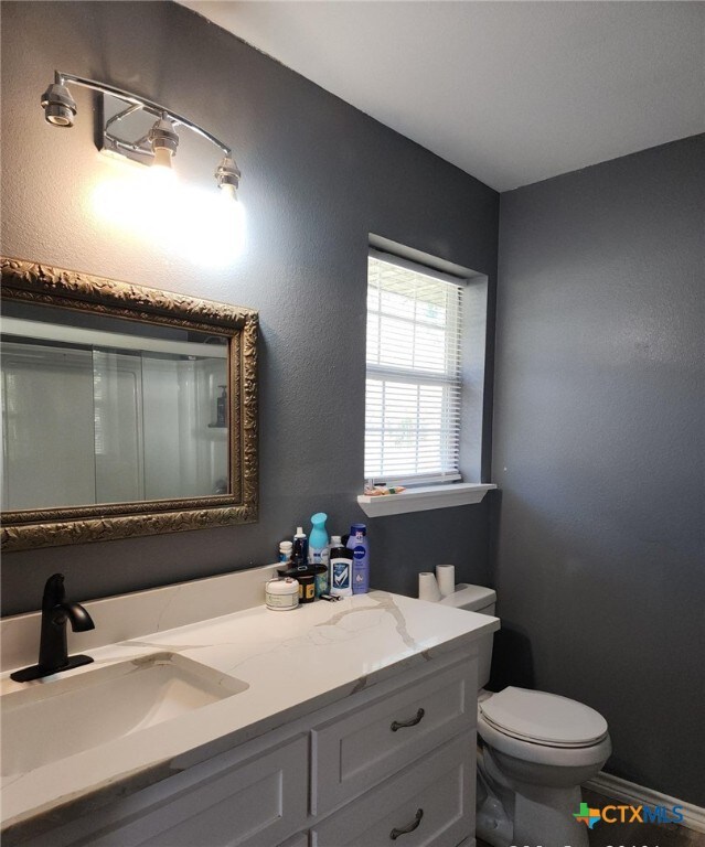 bathroom featuring vanity and toilet