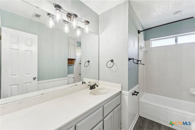 3400 Sally Cir, Kempner, TX 76539 - full bath featuring wood finished floors, bathtub / shower combination, vanity, toilet, and baseboards