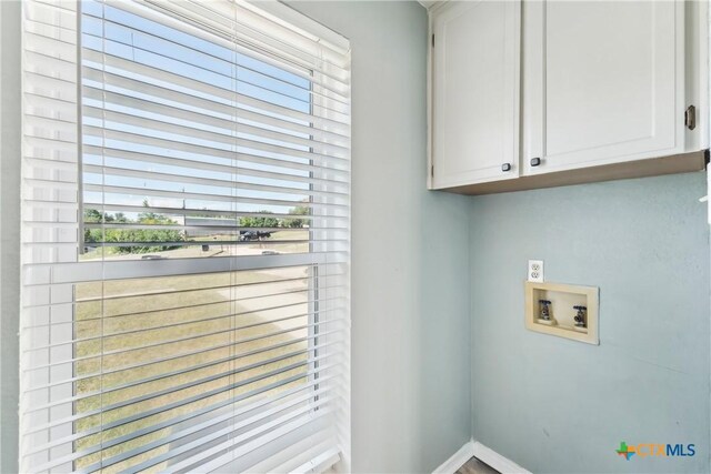 3400 Sally Cir, Kempner, TX 76539 - laundry area with cabinet space, hookup for a washing machine, and baseboards