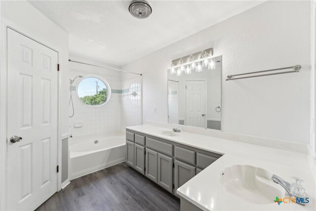 3400 Sally Cir, Kempner, TX 76539 - full bathroom featuring bathtub / shower combination, double vanity, and wood finished floors