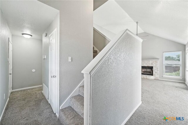 3400 Sally Cir, Kempner, TX 76539 - stairs featuring carpet flooring, a fireplace, vaulted ceiling, and baseboards