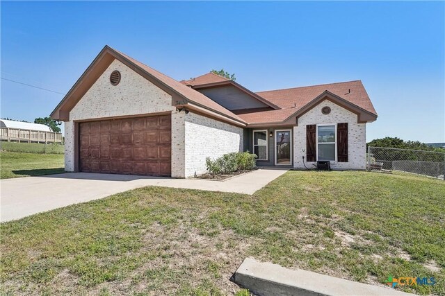 3400 Sally Cir, Kempner, TX 76539 - view of front facade with a garage, brick siding, and driveway