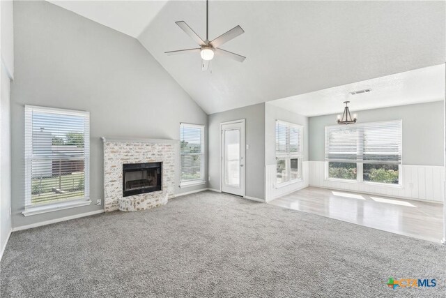 3400 Sally Cir, Kempner, TX 76539 - unfurnished living room featuring carpet floors, a fireplace, a chandelier, high vaulted ceiling, and a ceiling fan